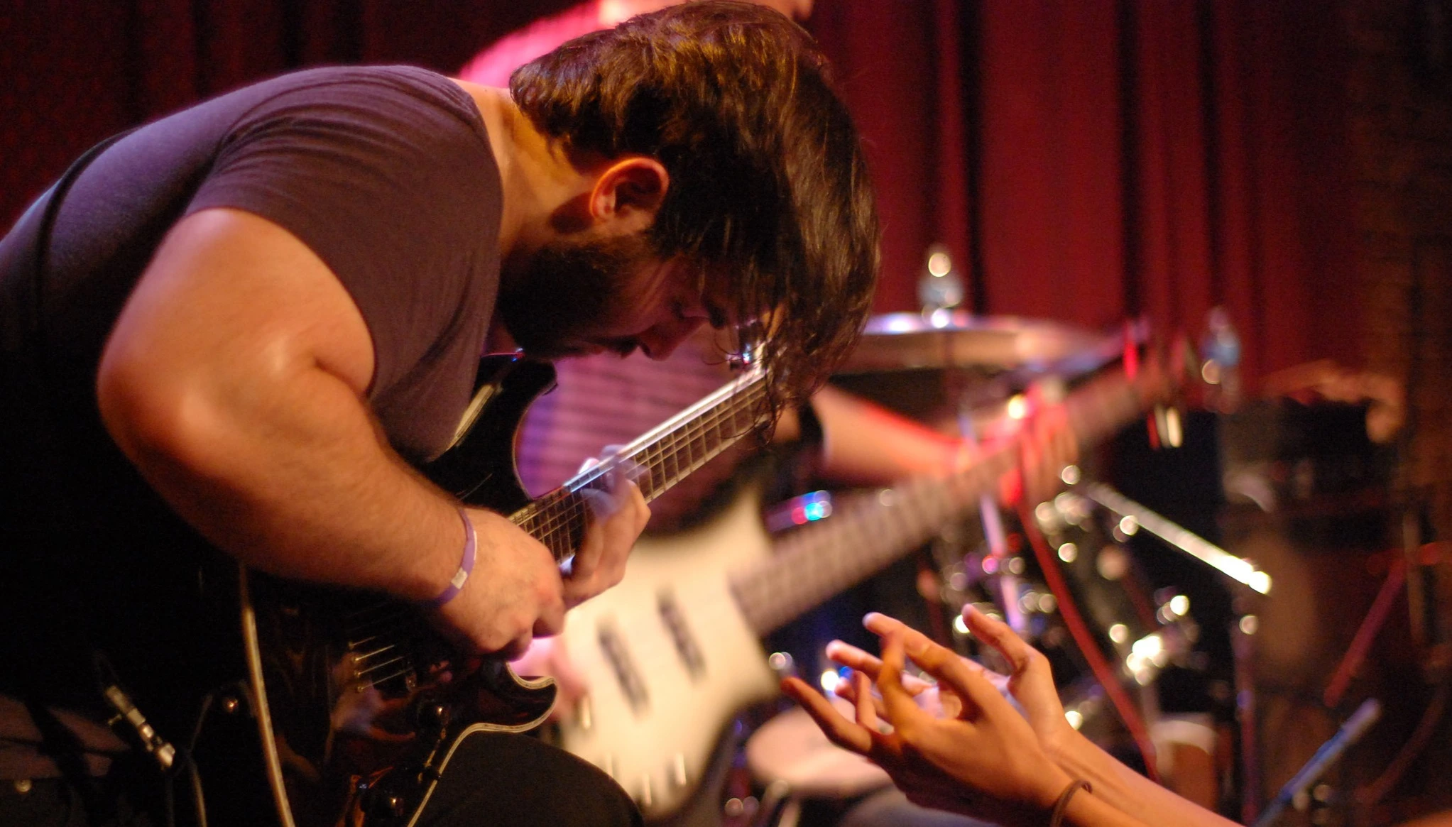 Evan Dingman performing live on guitar at a concert - epic orchestral and hybrid trailer music composer